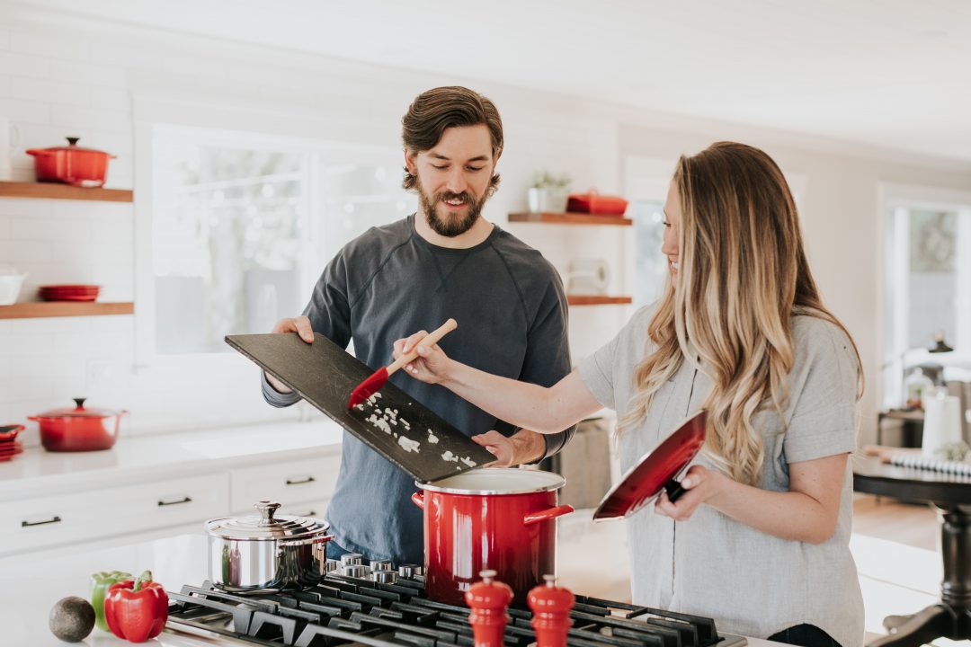 Couple in their kitchen, cooking dinner together