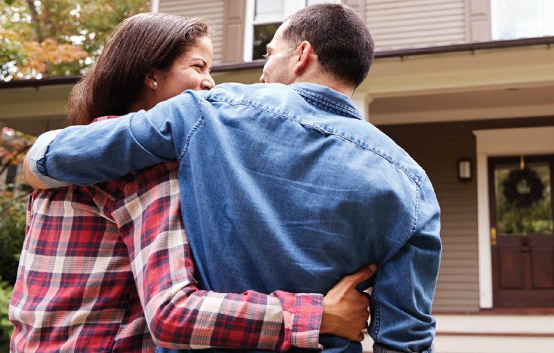 New Homeowners in front of home